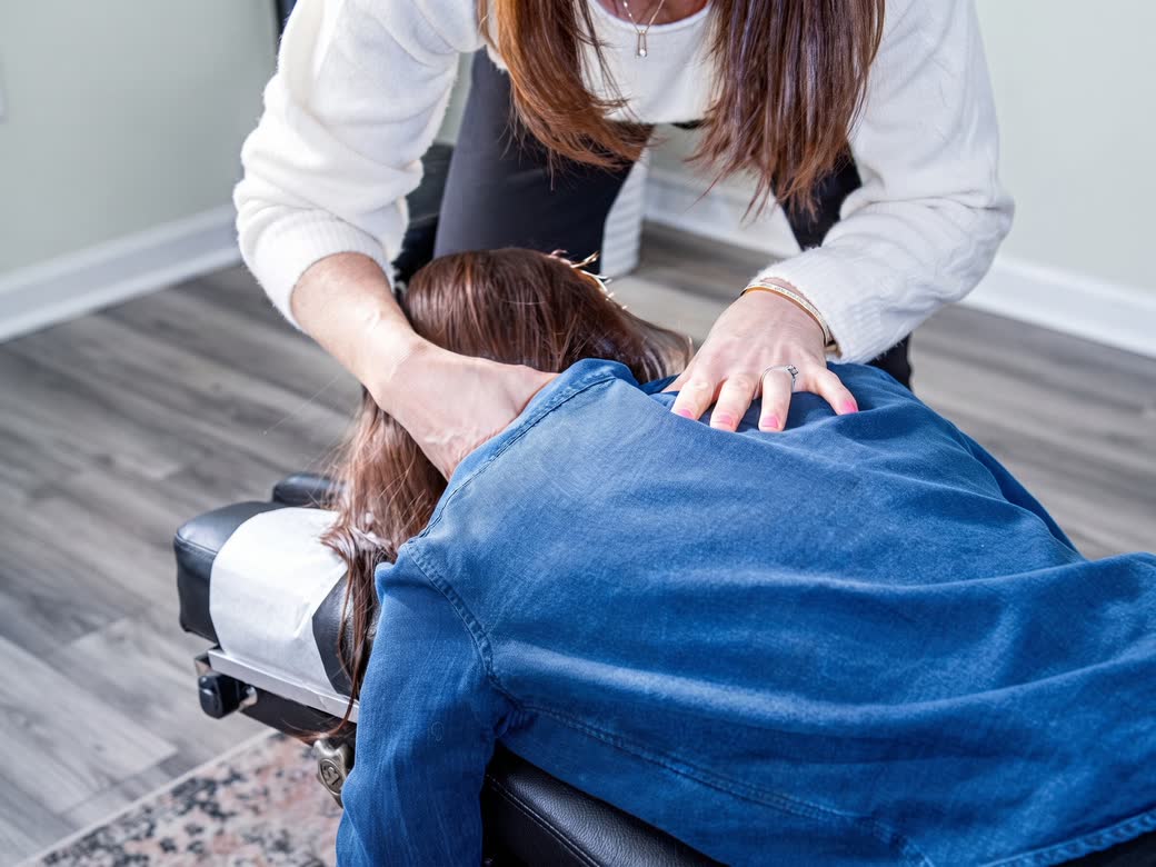 A practitioner treating a patient’s neck